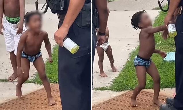 Shocking moment TODDLER swings at cops as officers try execute warrant